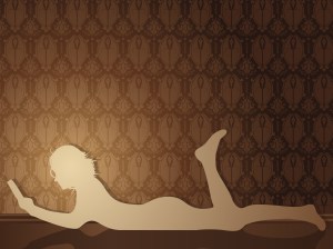 Girl reading a book on the floor.